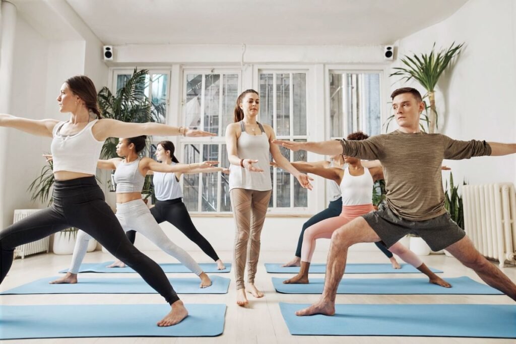 How to Become a Certified Yoga Instructor. Calm indoor yoga class promoting health and relaxation