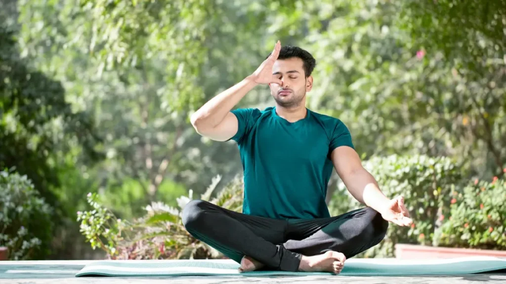 person practicing yoga breathing techniques to reduce stress
